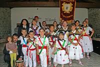 Grupo de danzadores y gaiteros bajo el asador